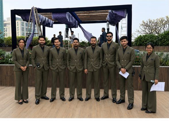 Hospitality staff in matching suits at an outdoor corporate venue