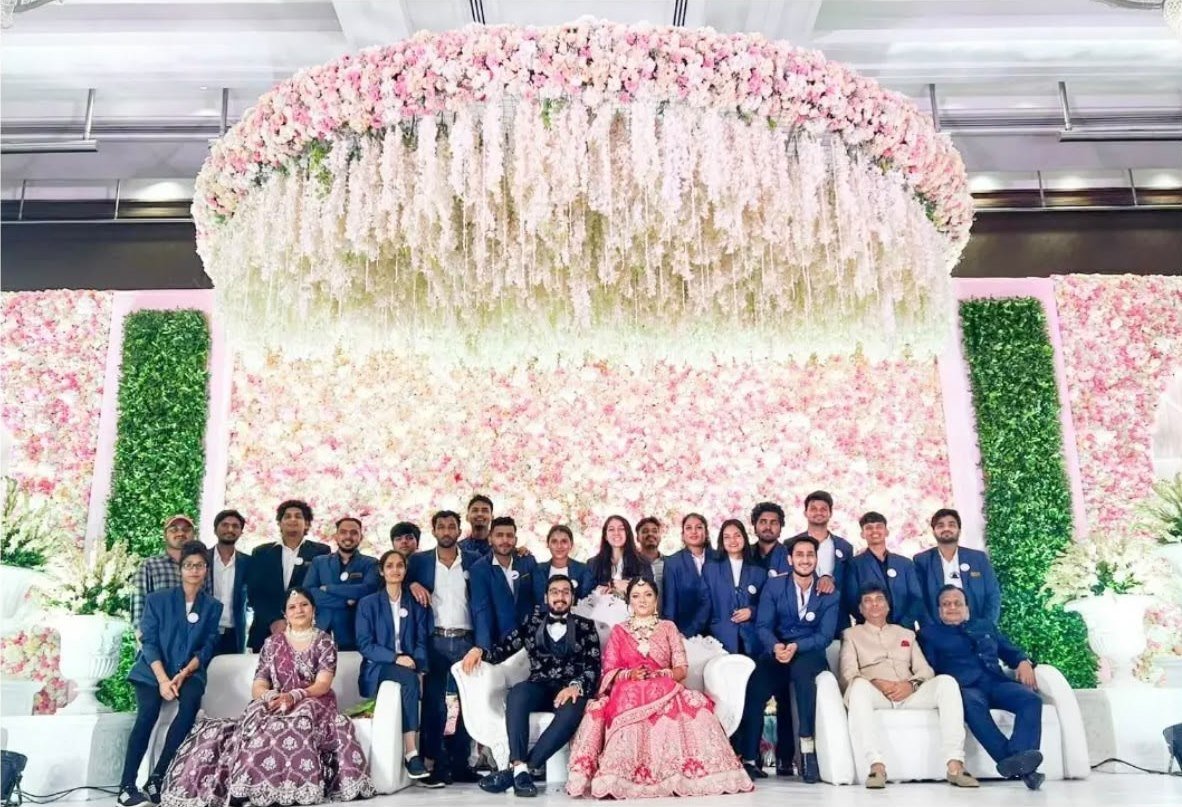 Hospitality team with the bride and groom at a grand wedding stage
